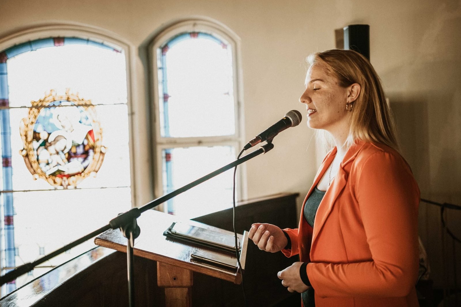 Sara singing during a church ceremony